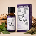A small amber glass bottle and its matching purple box for Animal Mintz Terp Topia, styled on a beige surface with mint leaves and dried cannabis buds in the background.